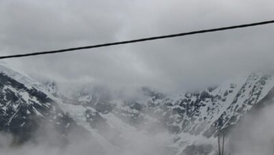 a snowy mountain with buildings