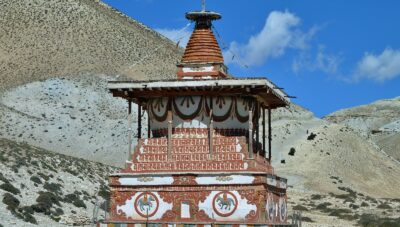 red and yellow temple near mountain under blue sky during daytime